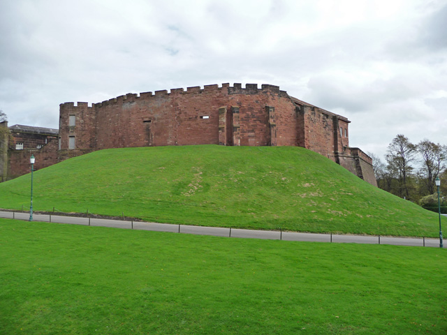 The oval motte of the castle with the half-moon tower visible at the left end.