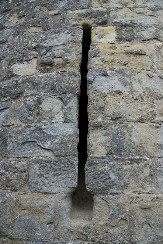 An arrow slit in the castle at Carcassone. Image courtesy of Flickr Commons and Thomas Quine.