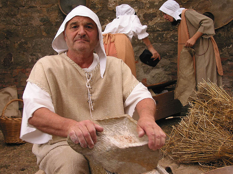 A man dressed as a medieval miller at a festival in Italy.